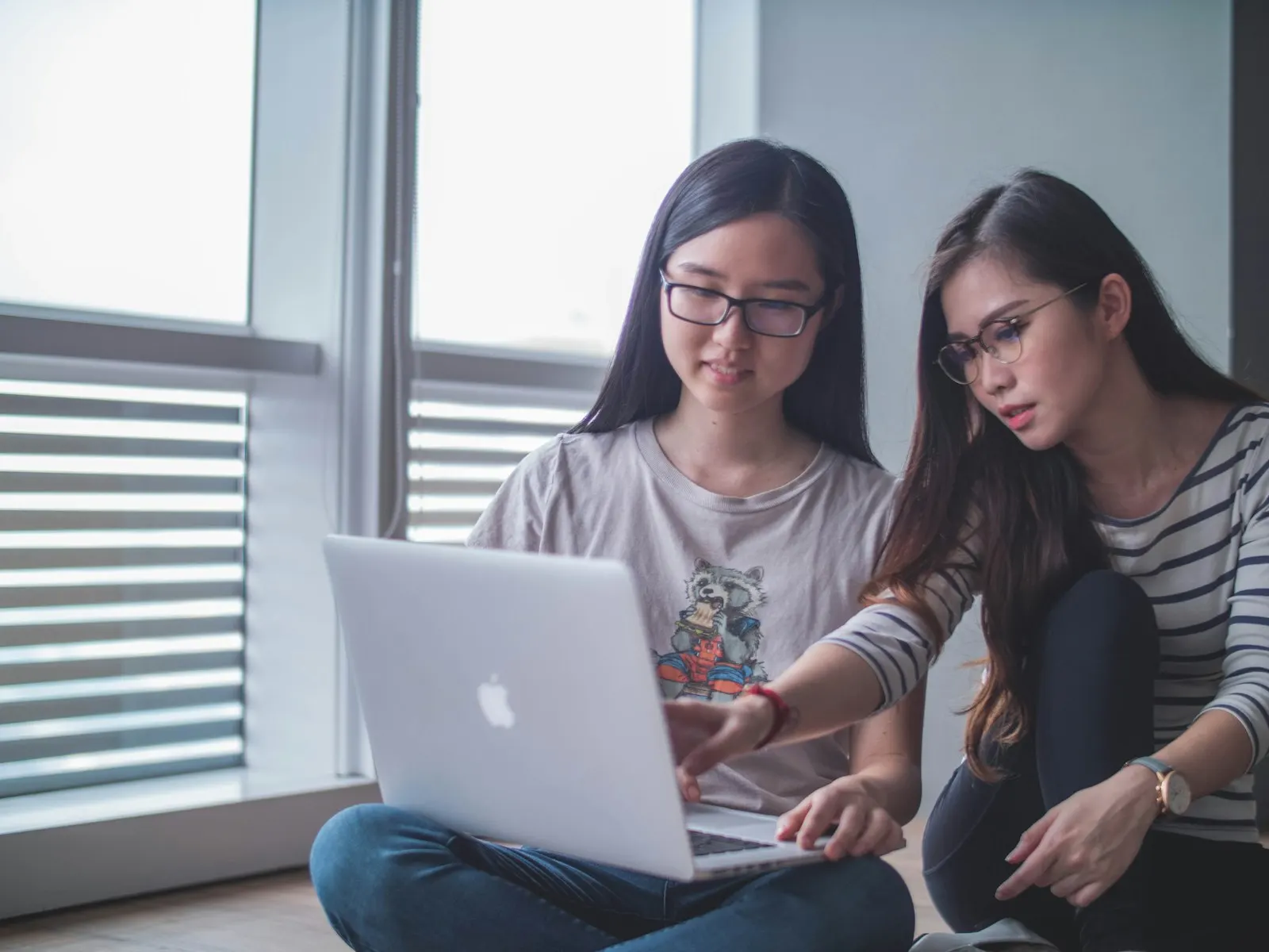 Two fullstack developers working through a feature together on a laptop.