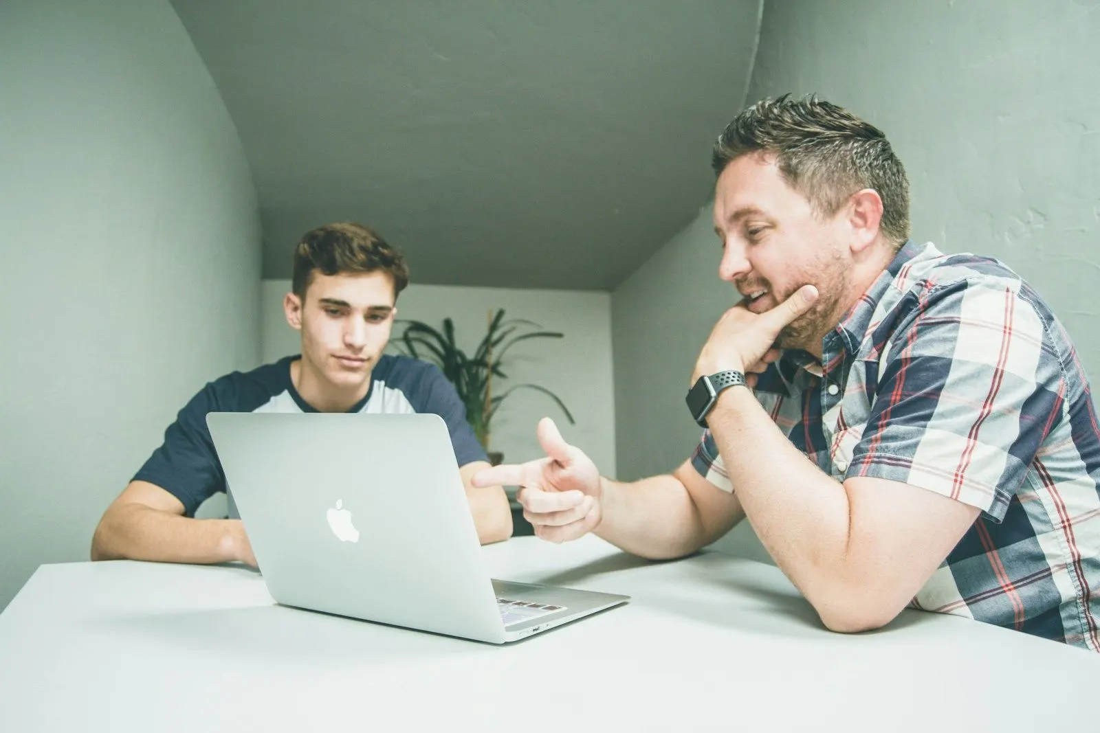 A Java streaming engineer explaining a Kafka setup to a colleague at a laptop.