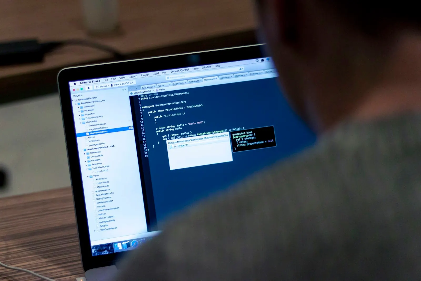 A Kotlin developer working through code in an editor on a laptop.