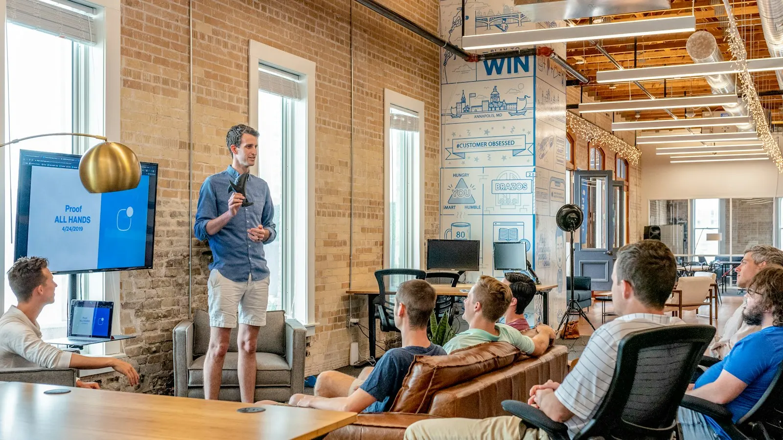A US onshore developer briefs his team in a brick-walled office.