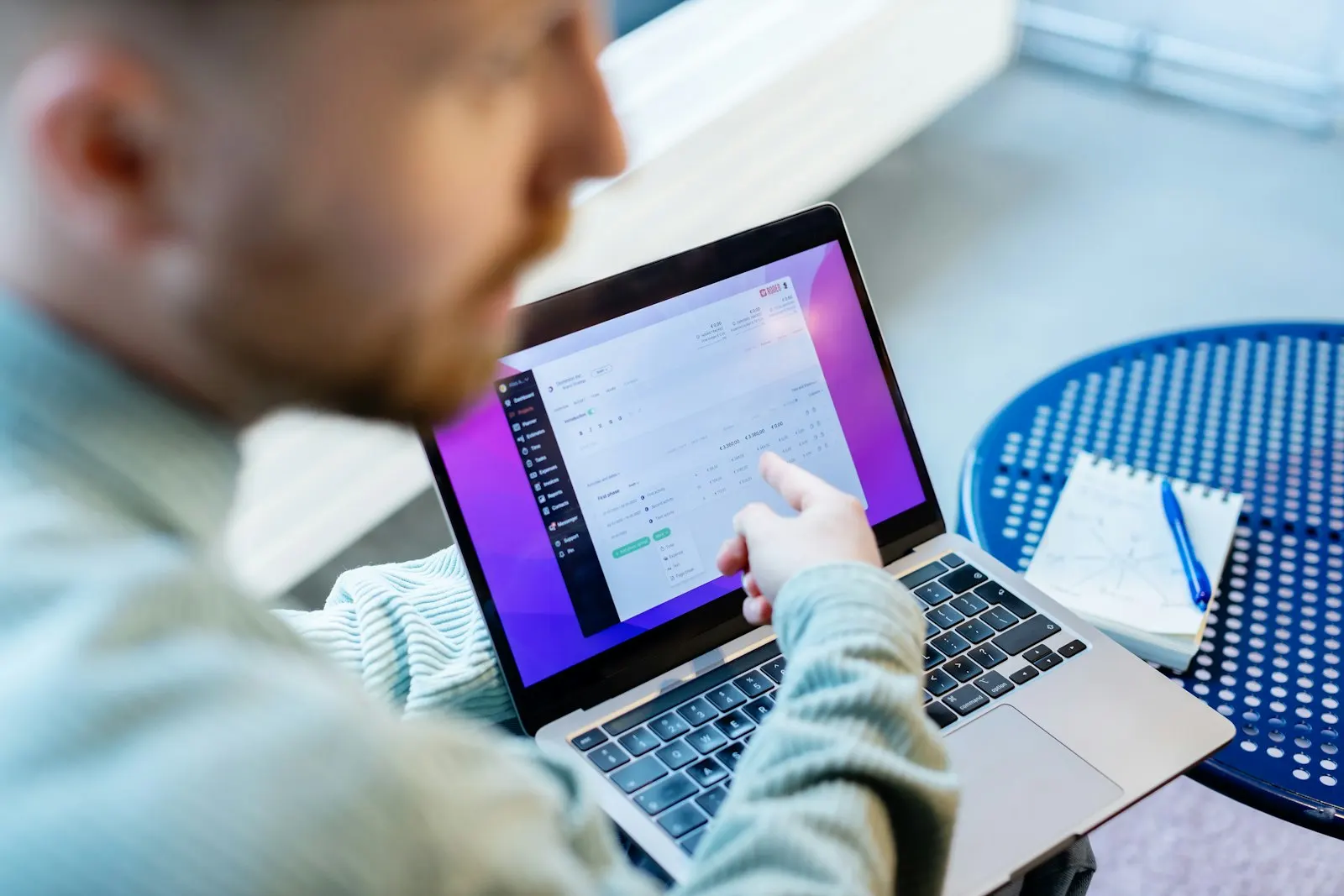 An engineer reviews work on a laptop.