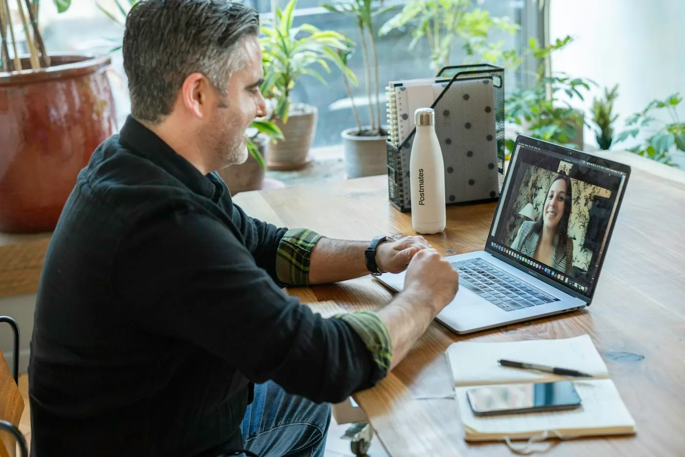 A team lead talks with an engineer on a video call.