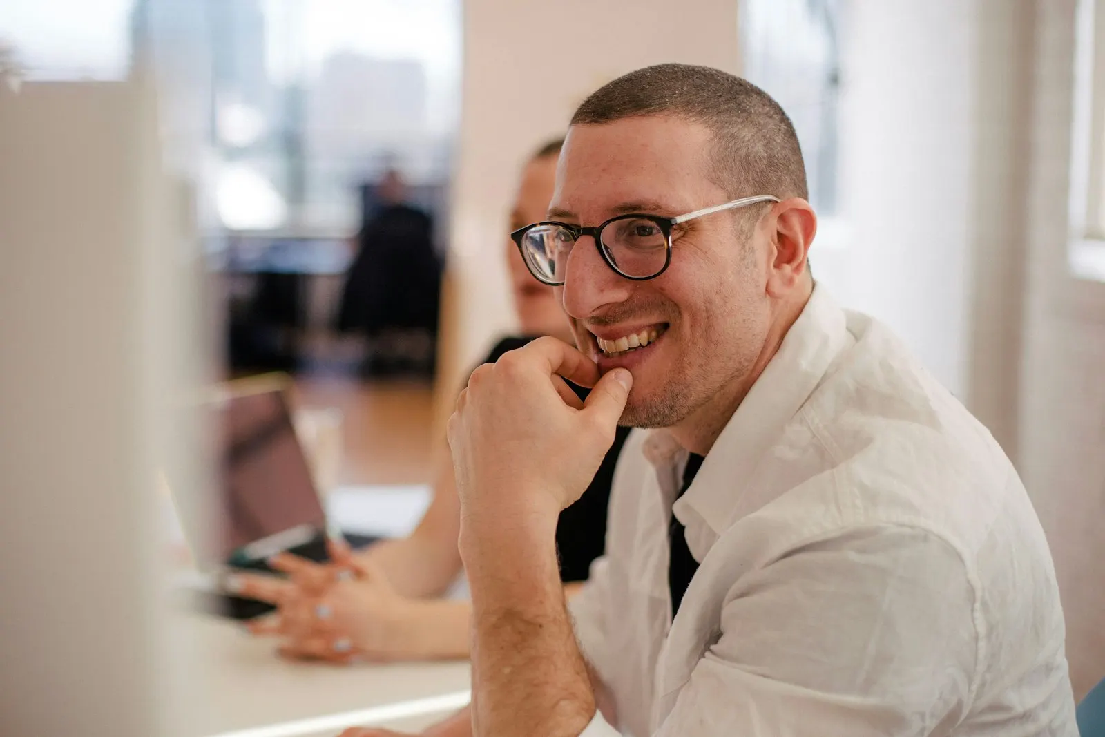 A nearshore QA engineer in Canada listens during a team meeting.