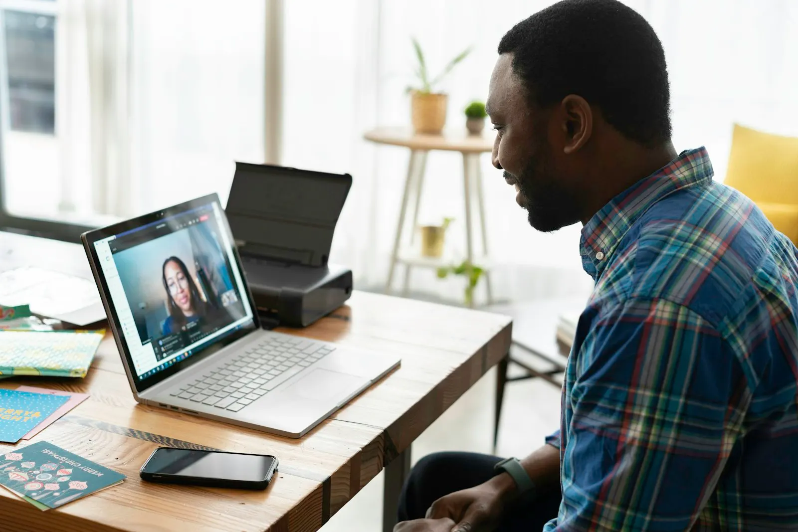 An engineer talks with a colleague on a video call.