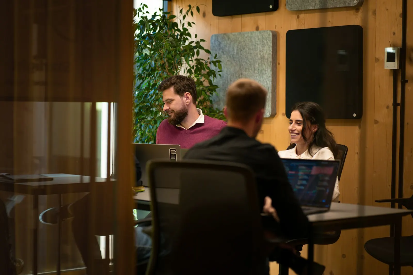 A team meets around a table with laptops to plan its first sprint.