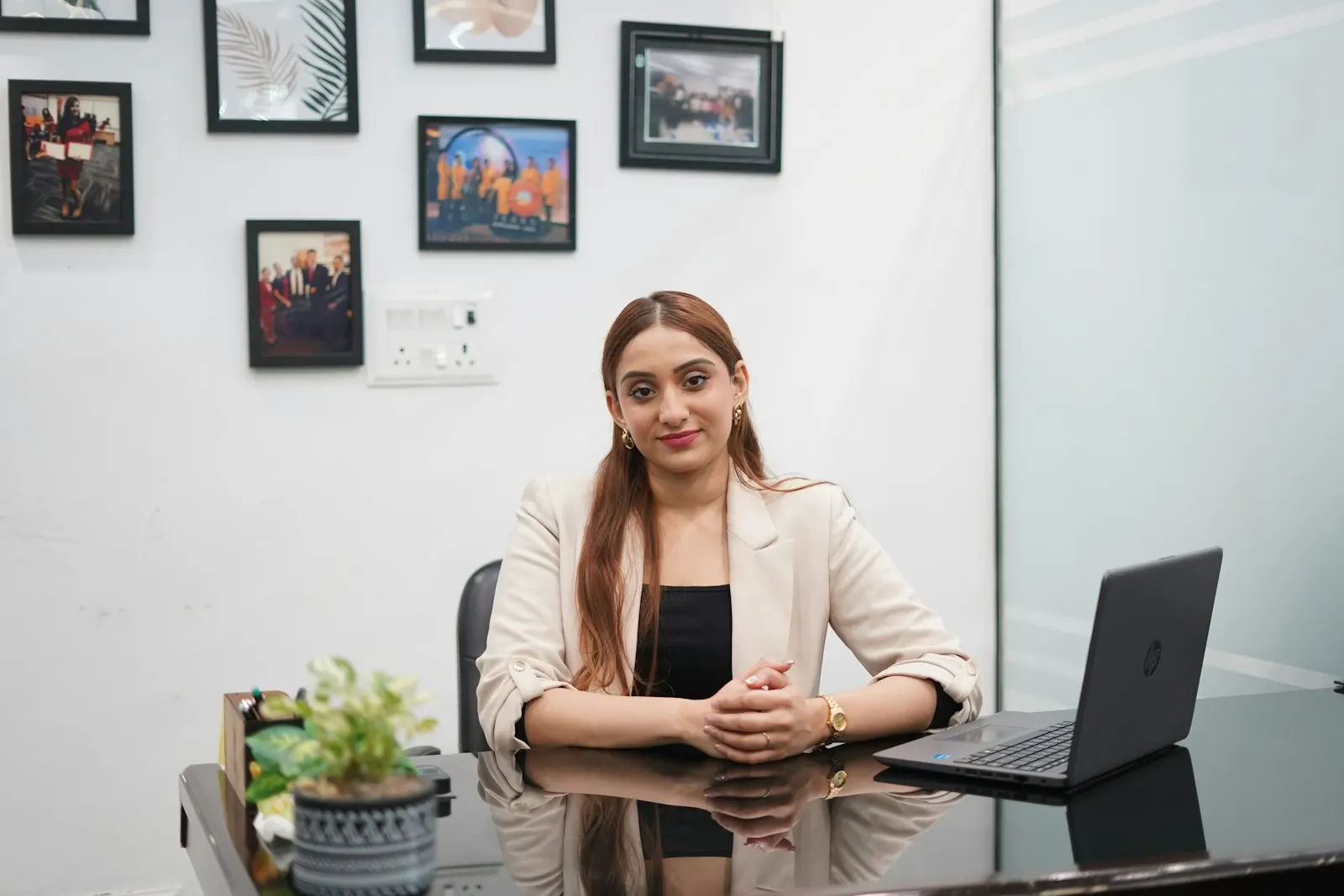 A center head at a global capability center in India sits at her desk beside a laptop.