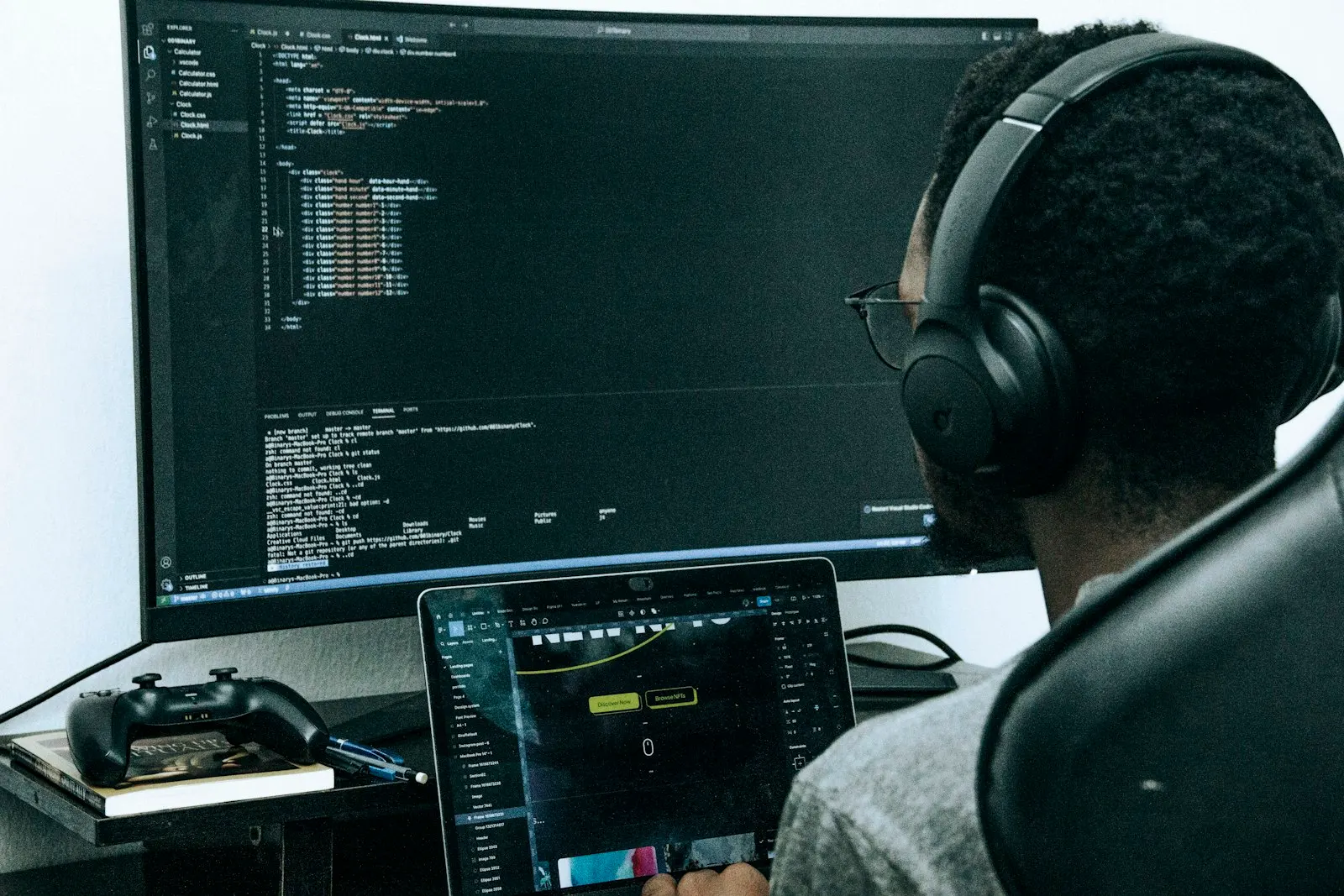 A DevOps engineer at a global capability center in India works at a large monitor.