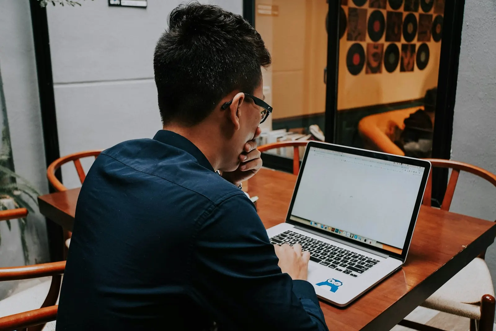 A full-stack engineer at a global capability center in India works on a laptop.