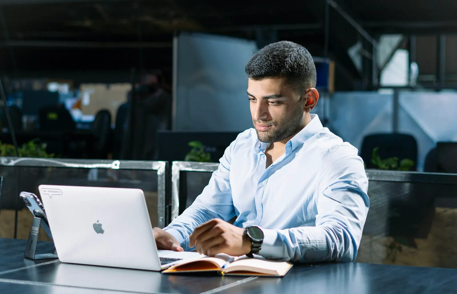 An engineering manager at a global capability center in India works at a laptop.