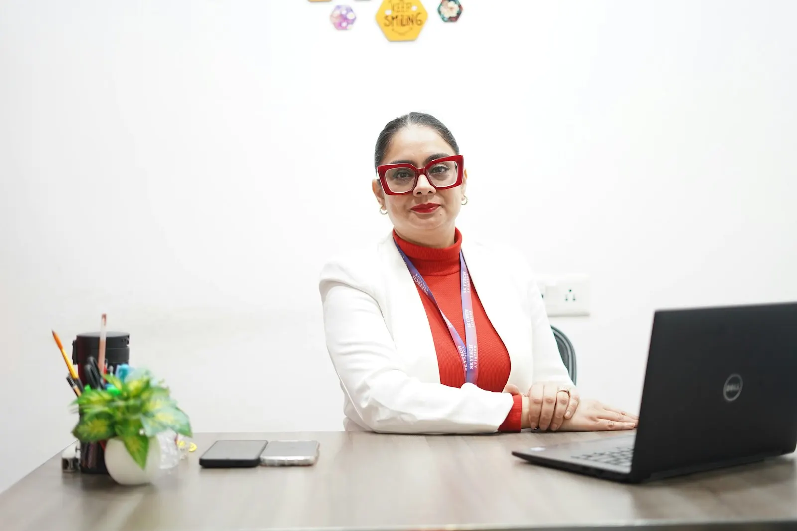 A leader at a global capability center in India sits at her desk with a laptop.