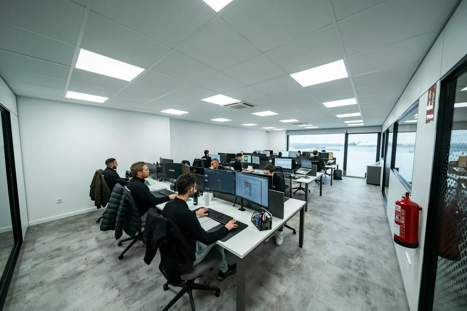 Engineers at a global capability center in India work at rows of desks in a bright office.
