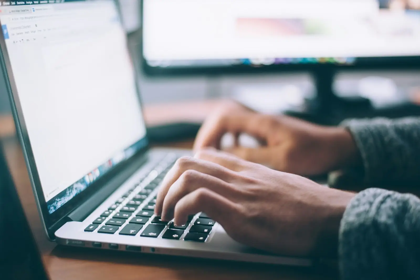 An AI specialist developer reviewing model diagrams on a laptop.